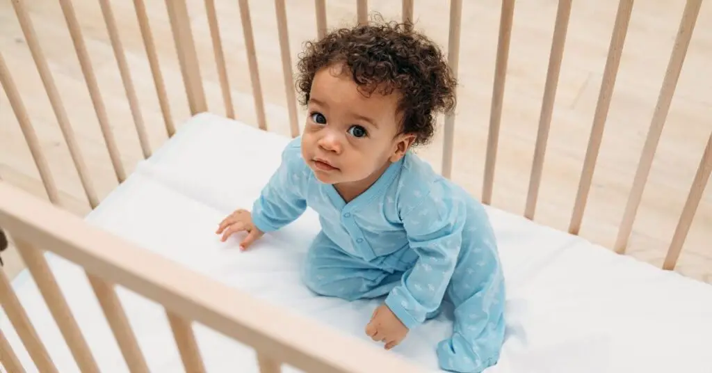 Baby Sits Up In Crib At Night